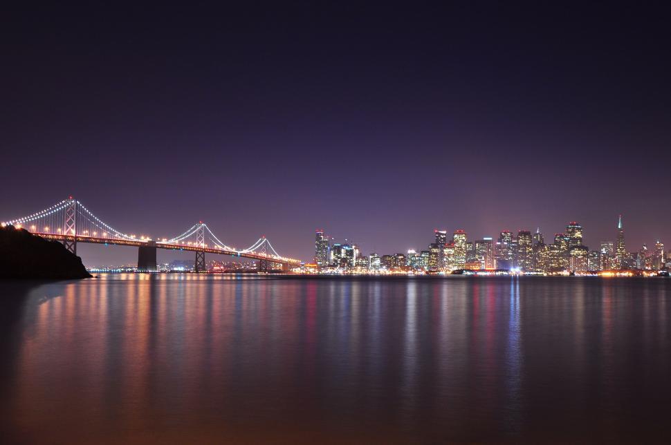 Free Image of City Skyline and Bridge Illuminated at Night 