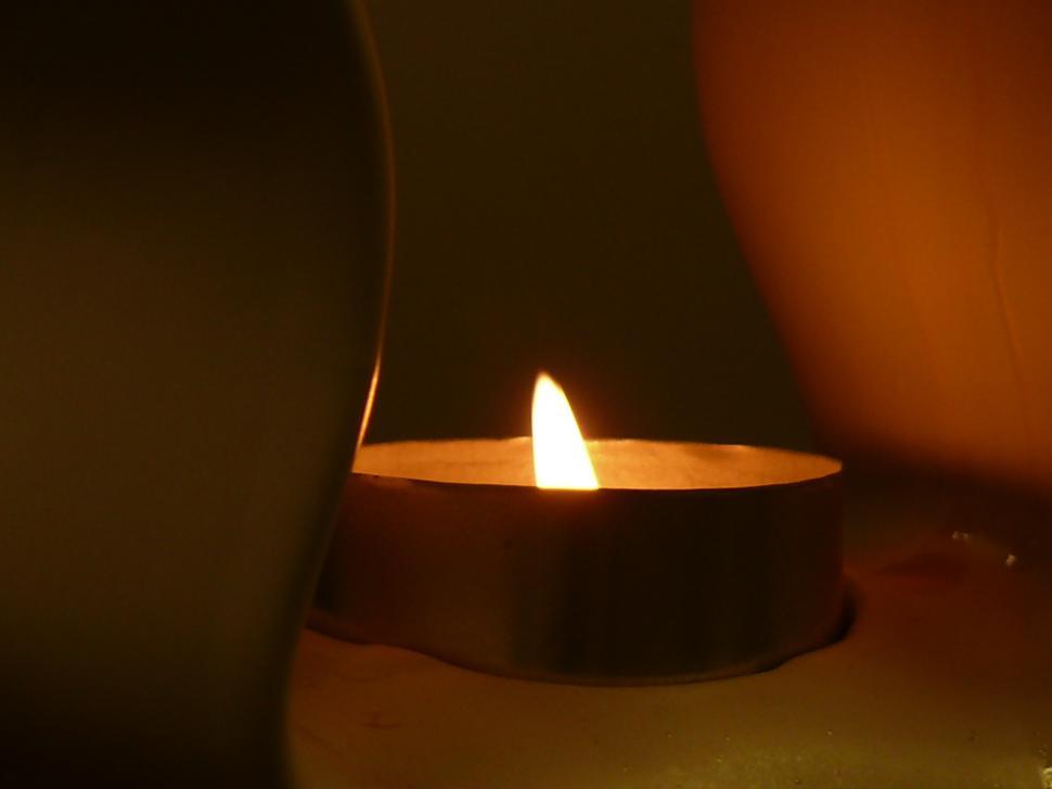 Free Image of A Lit Candle on a Table 