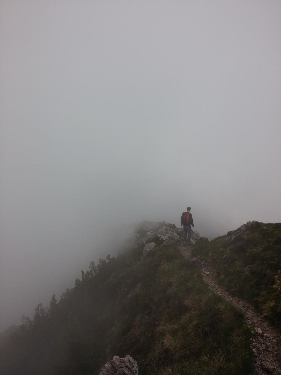 Free Image of Person Standing on Mountain Top in Fog 