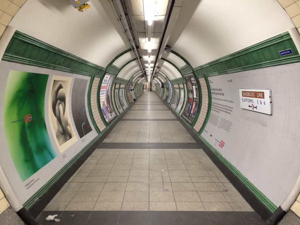 Free Image of Long Hallway With Green and White Sign 