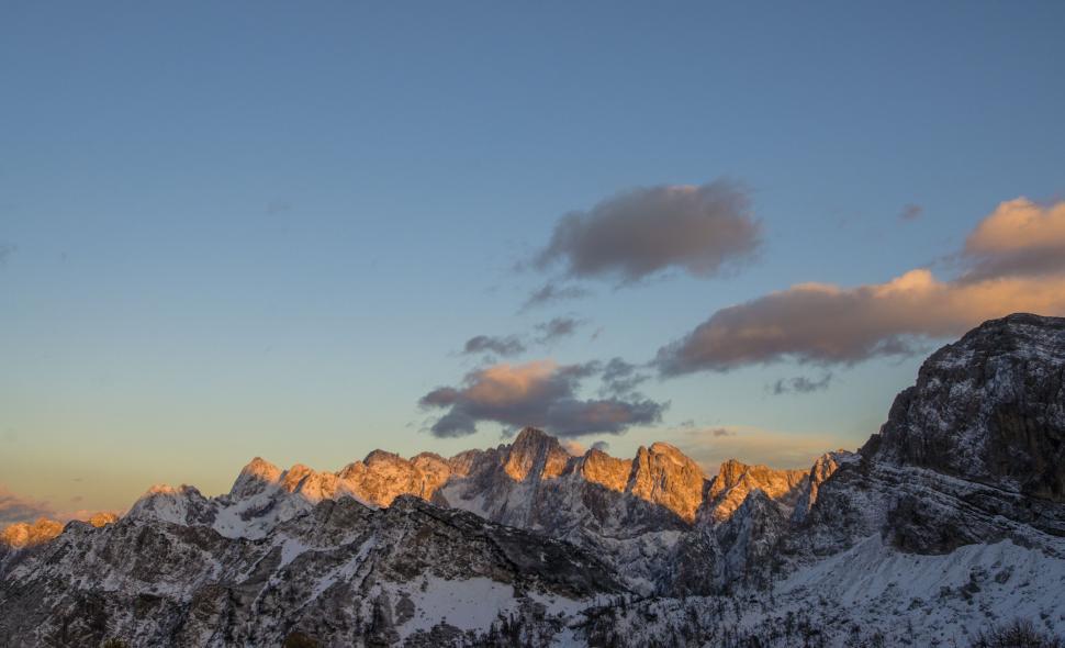 Free Image of Majestic Mountain Range Silhouetted Against Setting Sun 