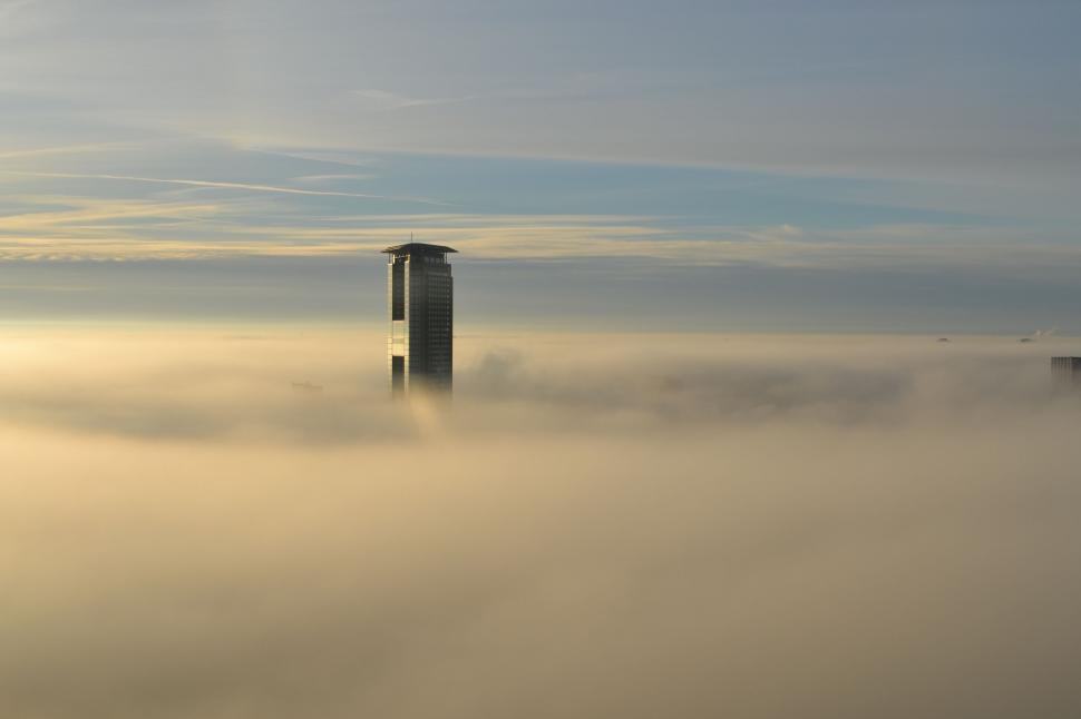 Free Image of Tall Building Amidst Foggy Sky 
