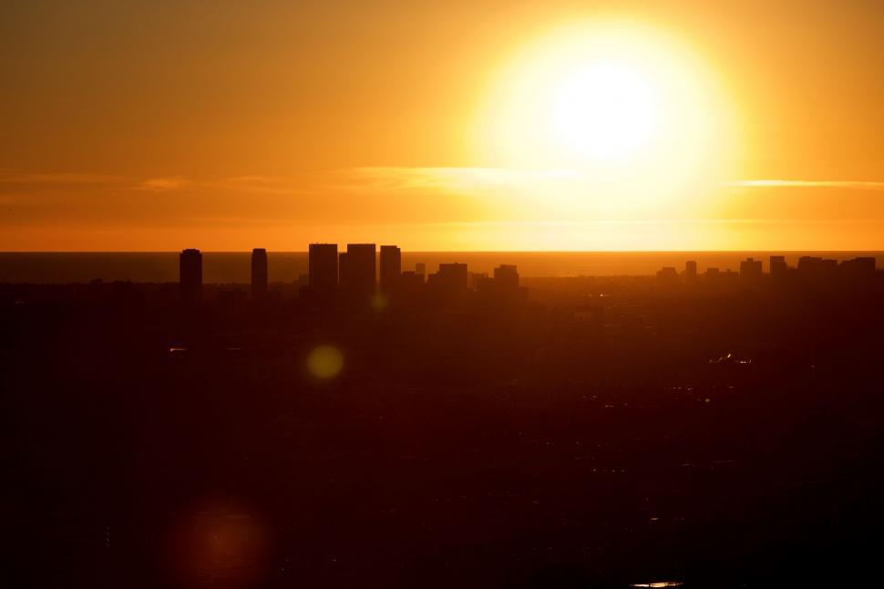 Free Image of Sun Setting Over City Skyline 
