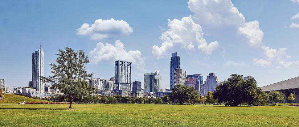 Free Image of Grassy Field With City in Background 