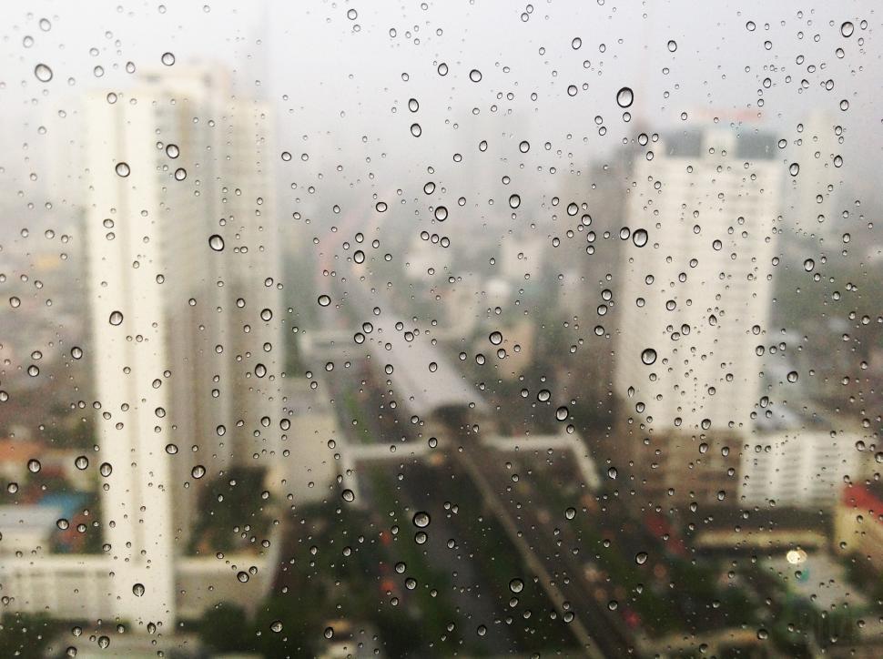 Free Image of Cityscape Through Rain-Covered Window 