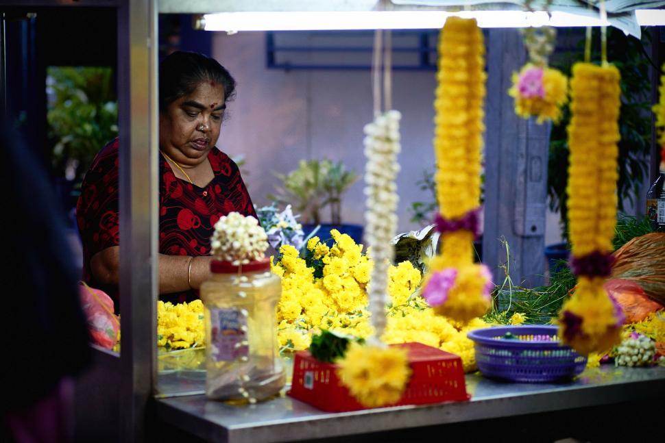 Free Image of Woman Arranging Flowers in a Flower Shop 