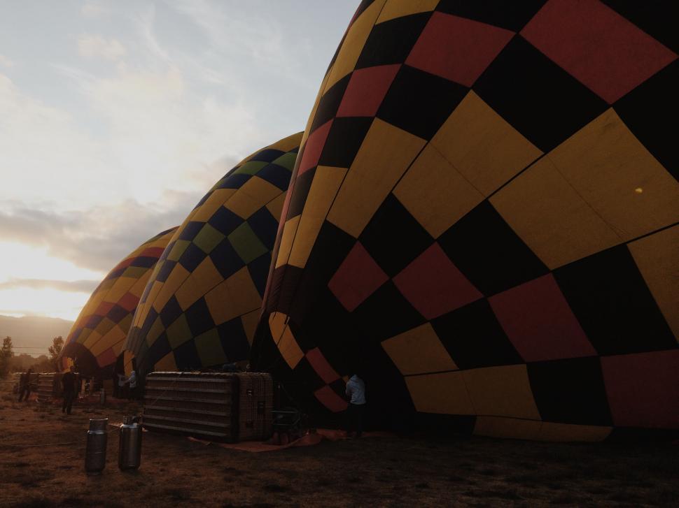 Free Image of Group of People Standing Next to Giant Hot Air Balloon 