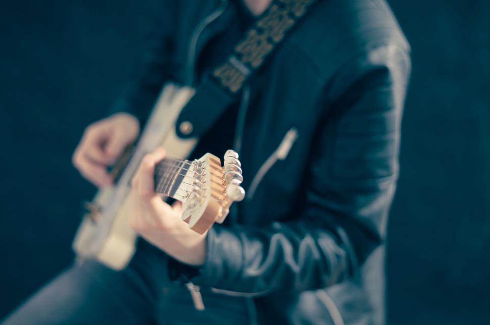Free Image of Man Holding a Guitar 