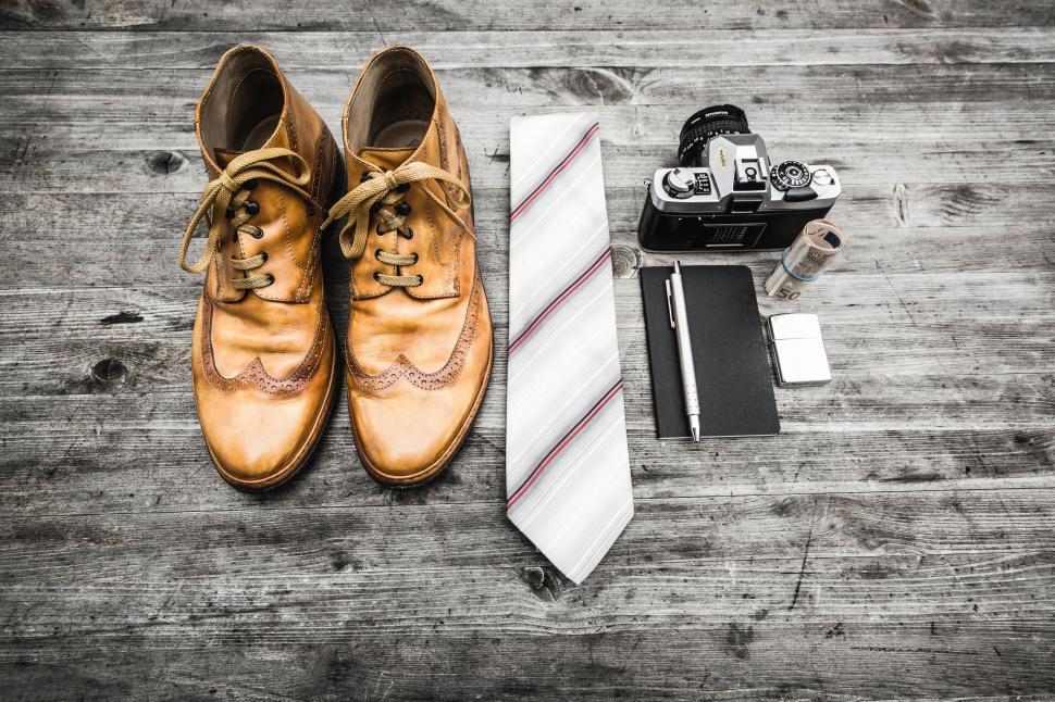 Free Image of Shoes, Tie, and Camera on Wooden Floor 