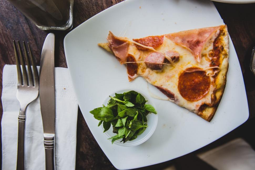 Free Image of A Slice of Pizza on a White Plate 
