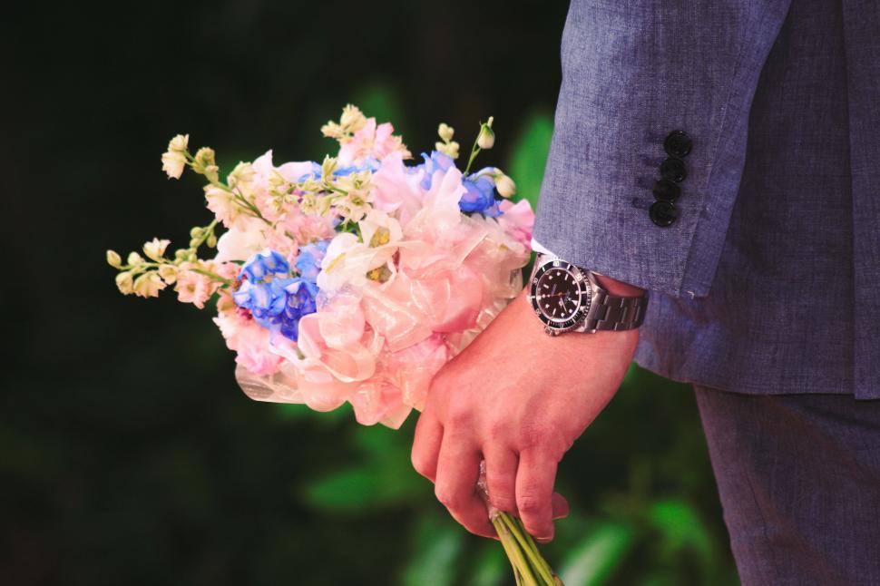 Free Image of Man in Suit Holding Bouquet of Flowers 