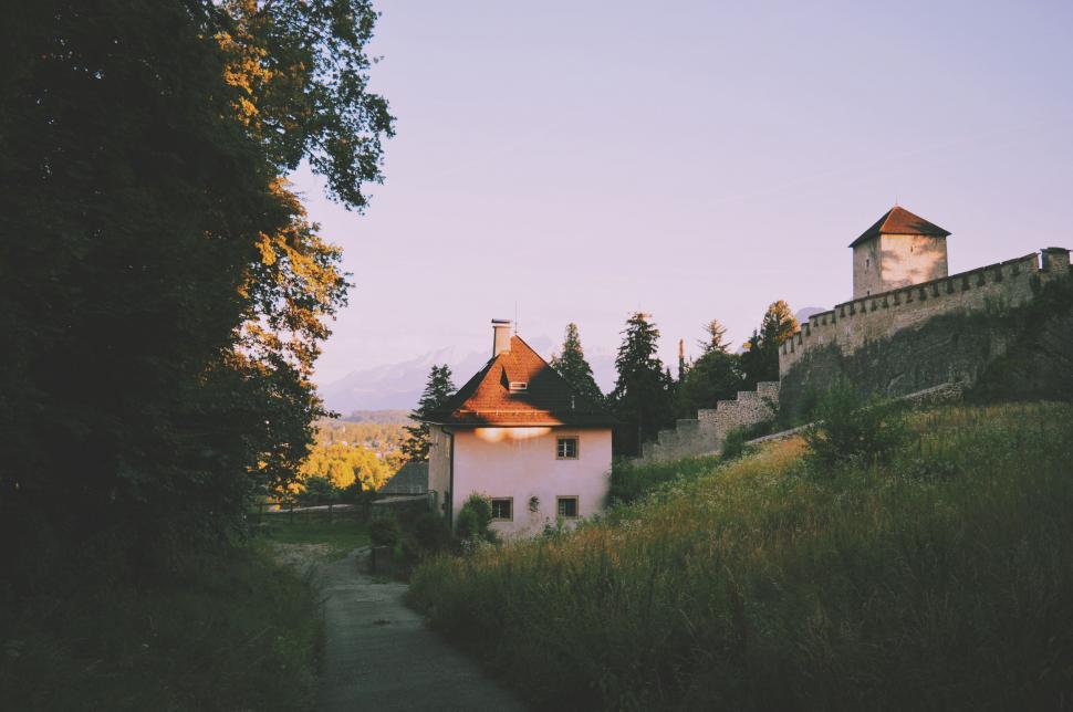 Free Image of Castle on a Hill With Trees in the Foreground 