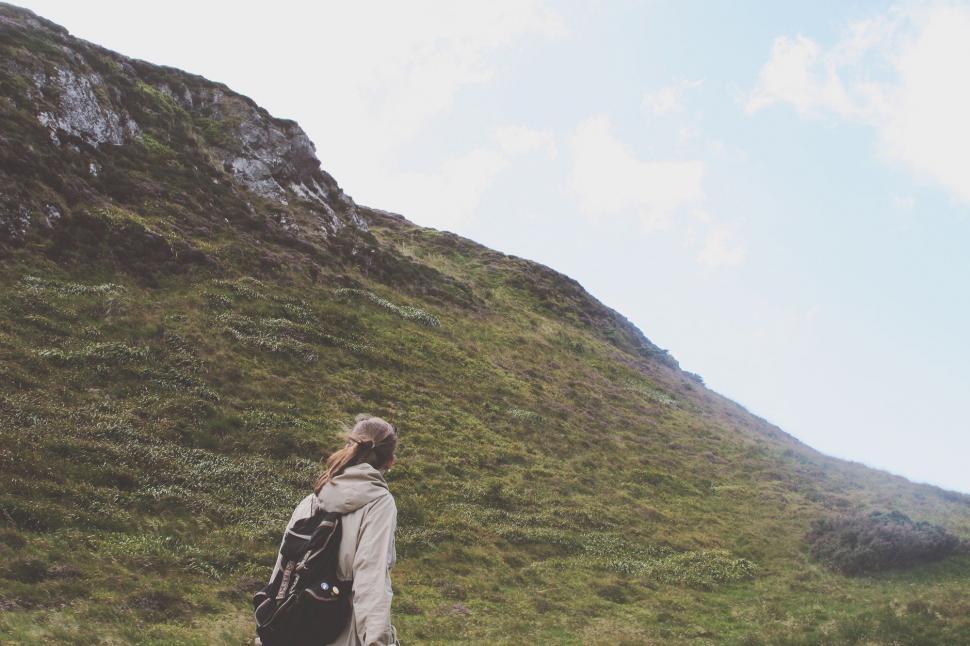 Free Image of Person Walking Up Hill With Backpack 