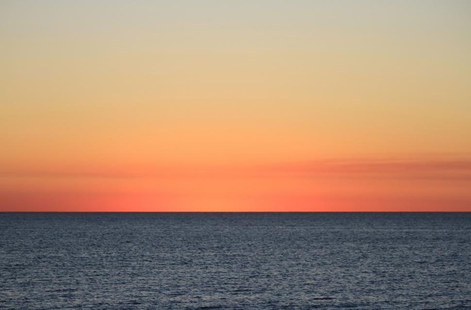 Free Image of The Sun Sets Over the Ocean 