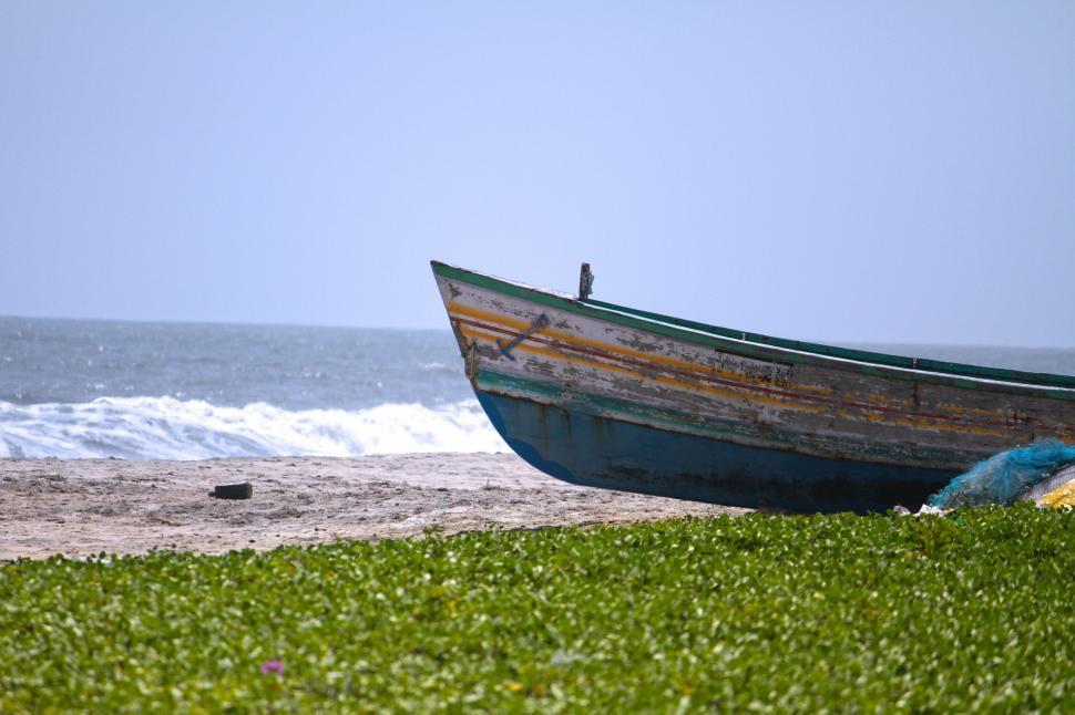 Free Image of Boat Resting on Lush Green Field 