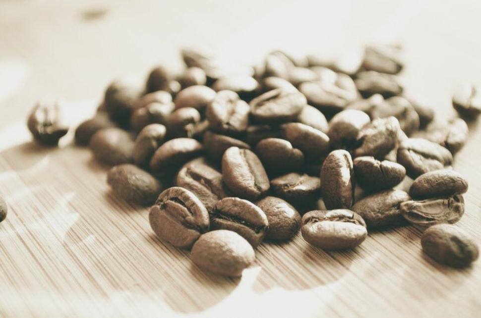 Free Image of Heap of Coffee Beans on Wooden Table 