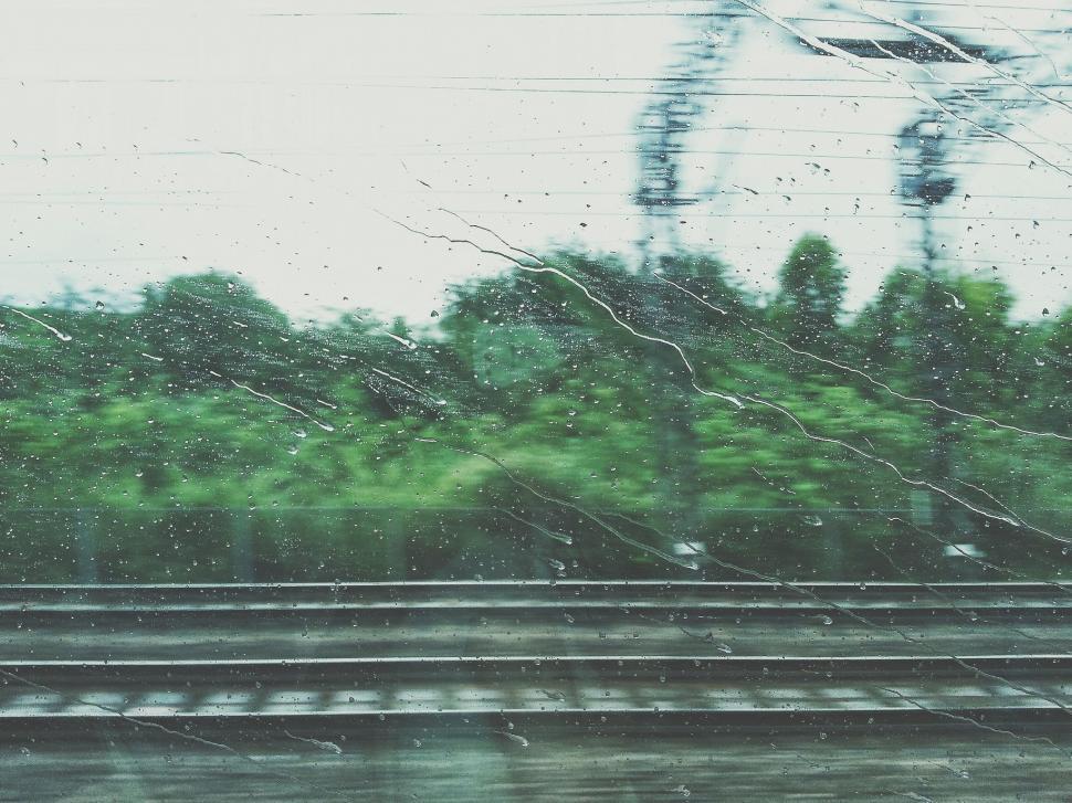 Free Image of A View of a Train Track Through a Rain Covered Window 