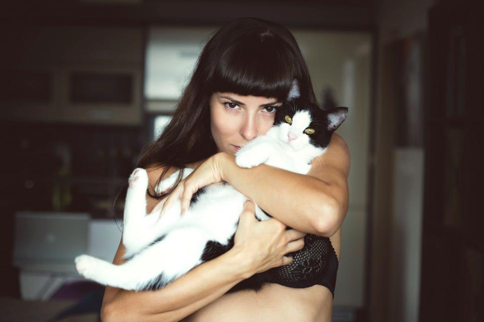 Free Image of Woman Holding a Cat in Her Arms 