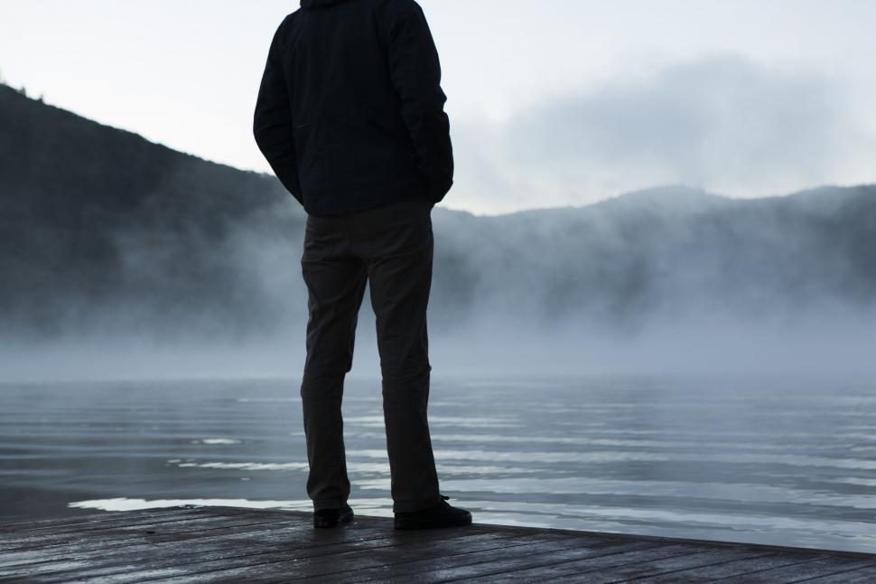 Free Image of Man Standing on Dock in Fog 