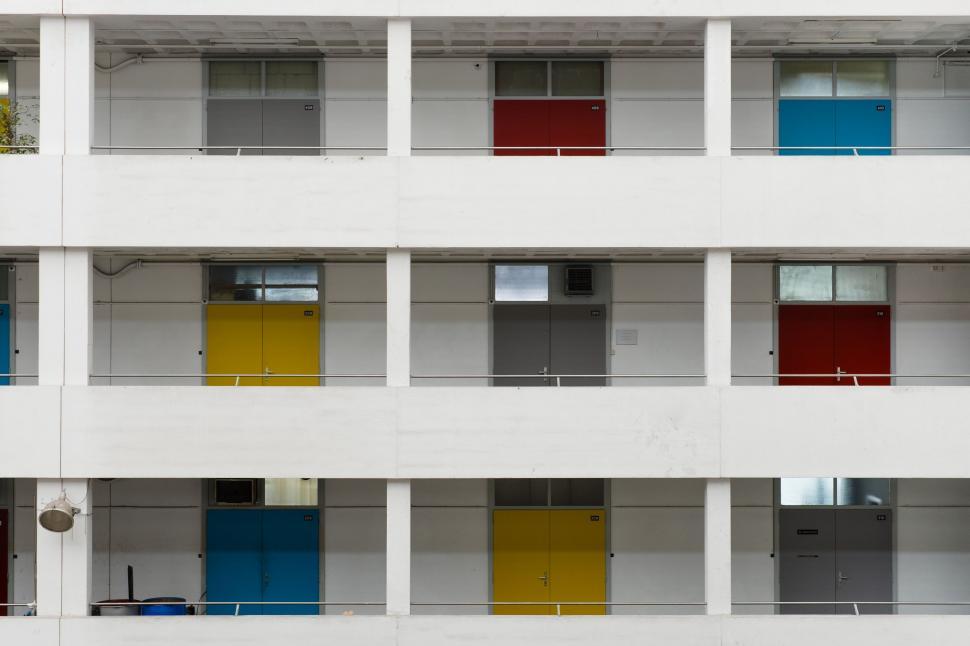 Free Image of White Building With Colorful Windows and Balconies 