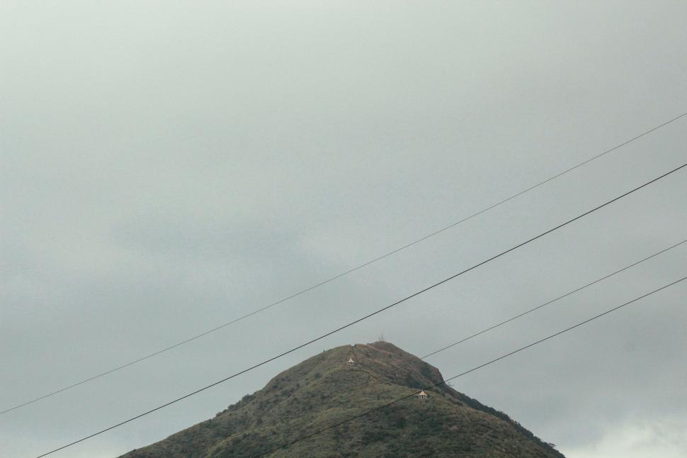 Free Image of Mountain With Power Lines on Cloudy Day 