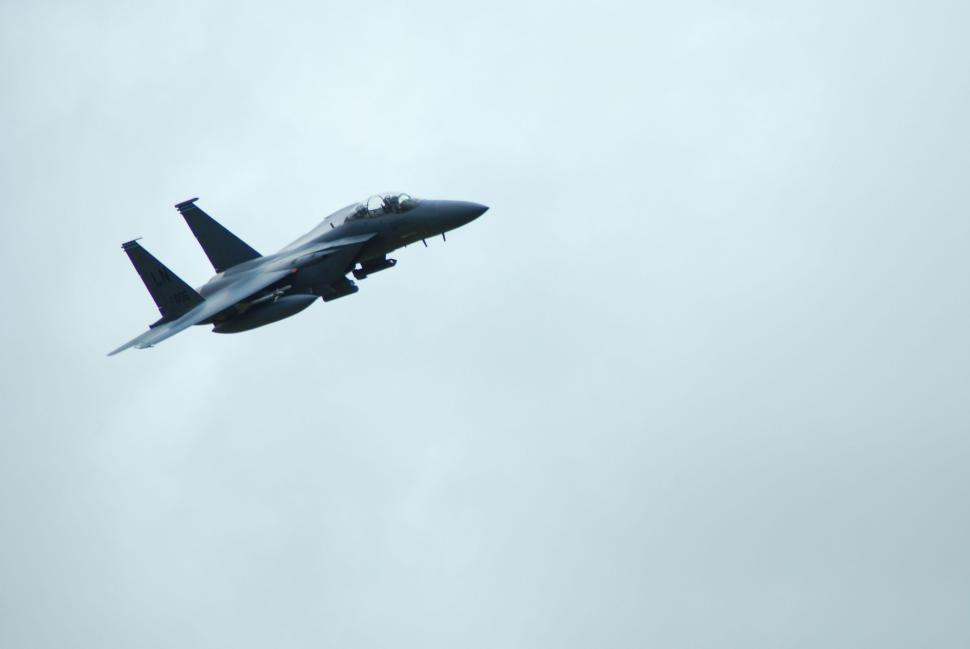 Free Image of Fighter Jet Flying Through Cloudy Sky 