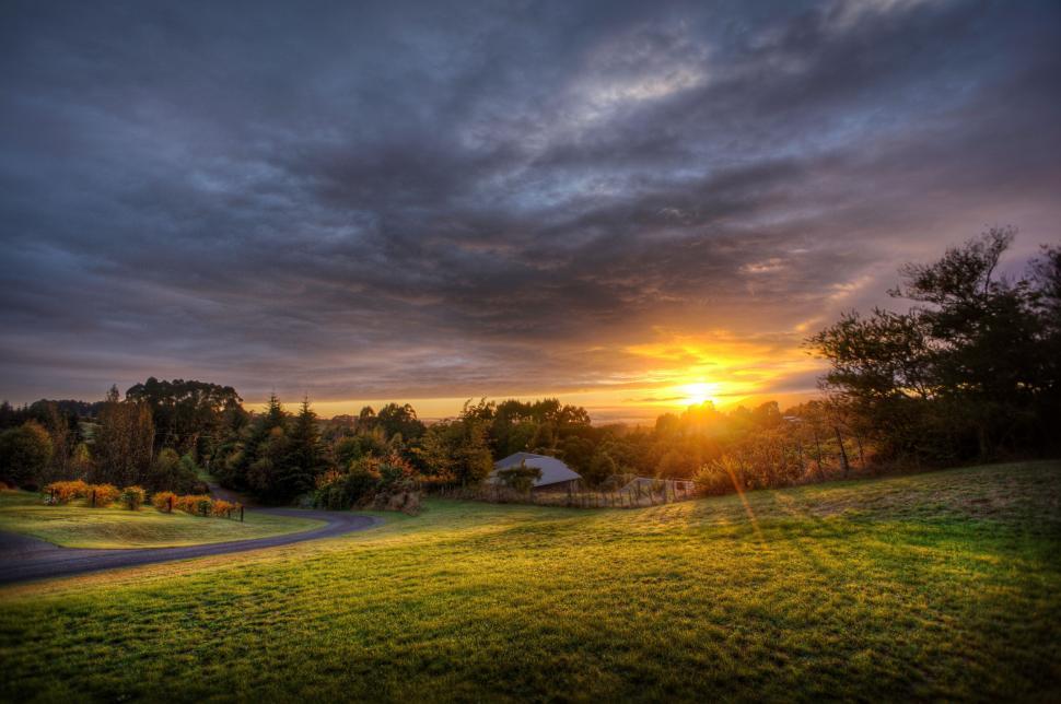 Free Image of Sun Setting Over Grassy Field 