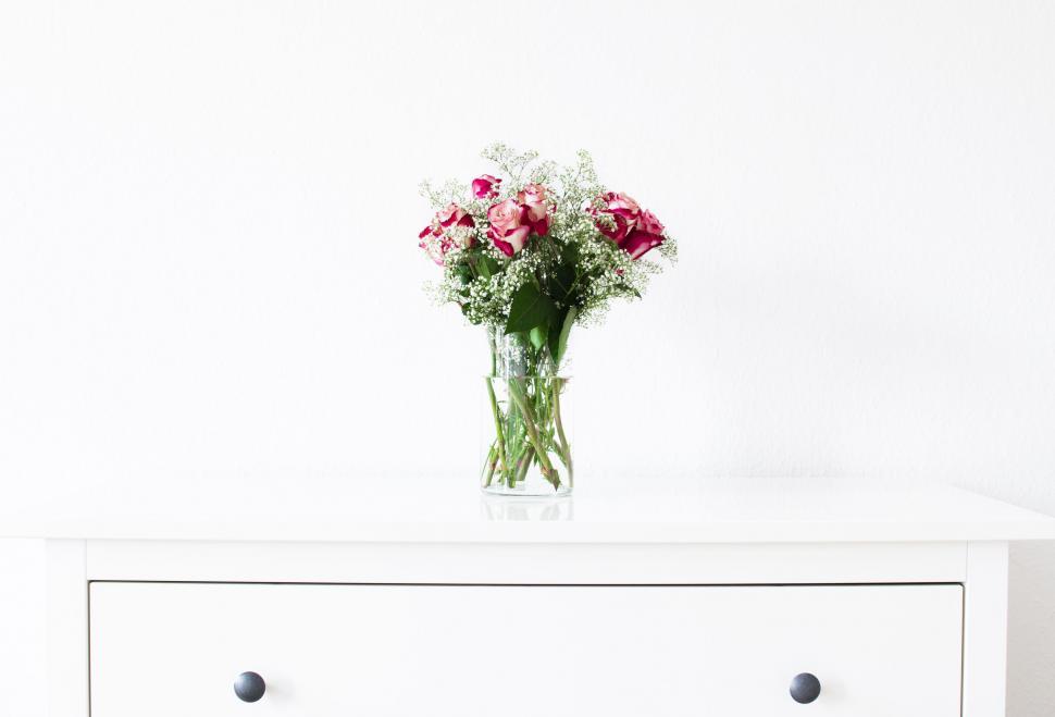 Free Image of Vase of Flowers on White Dresser 