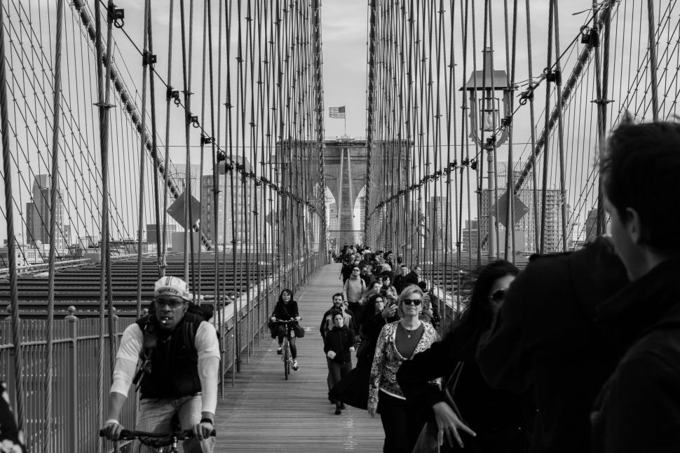 Free Image of Group of People Riding Bikes Across a Bridge 