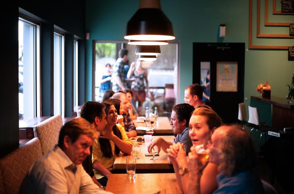 Free Image of Group of People Sitting at a Restaurant Table 
