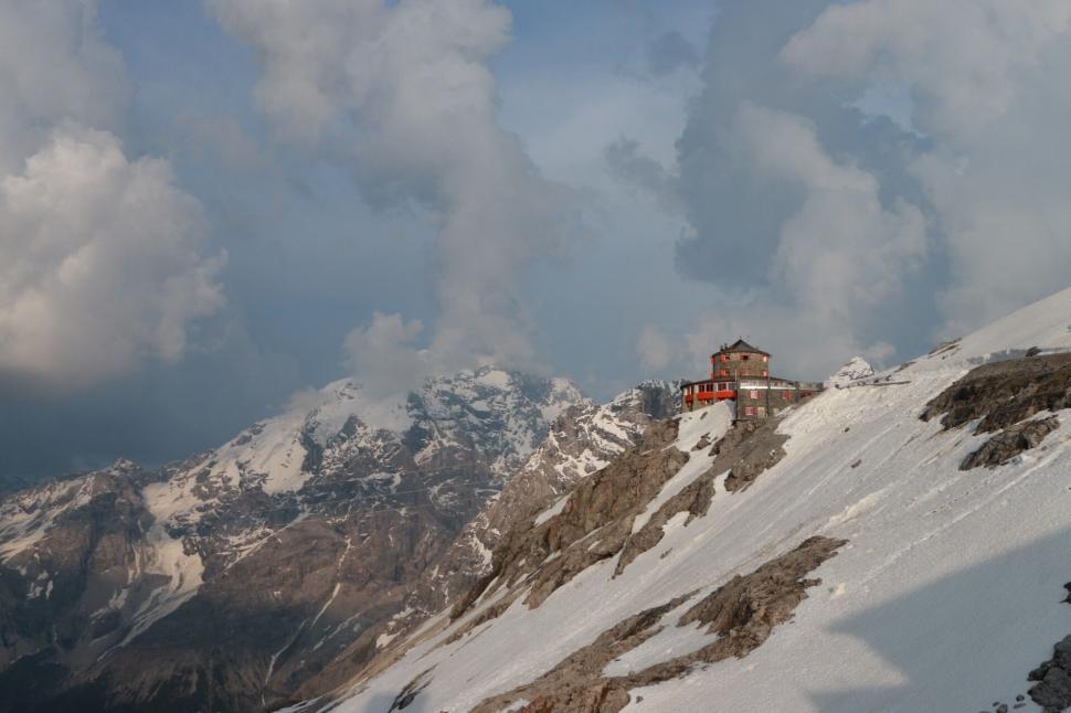 Free Image of Snow Covered Mountain With Small House 