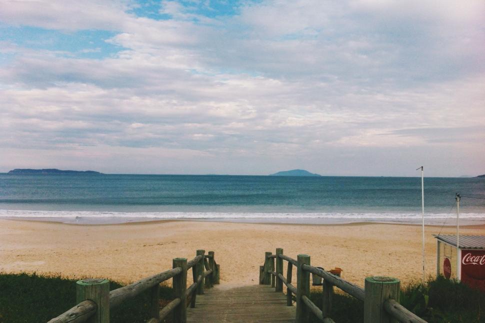 Free Image of Wooden Walkway Leading to Sandy Beach 