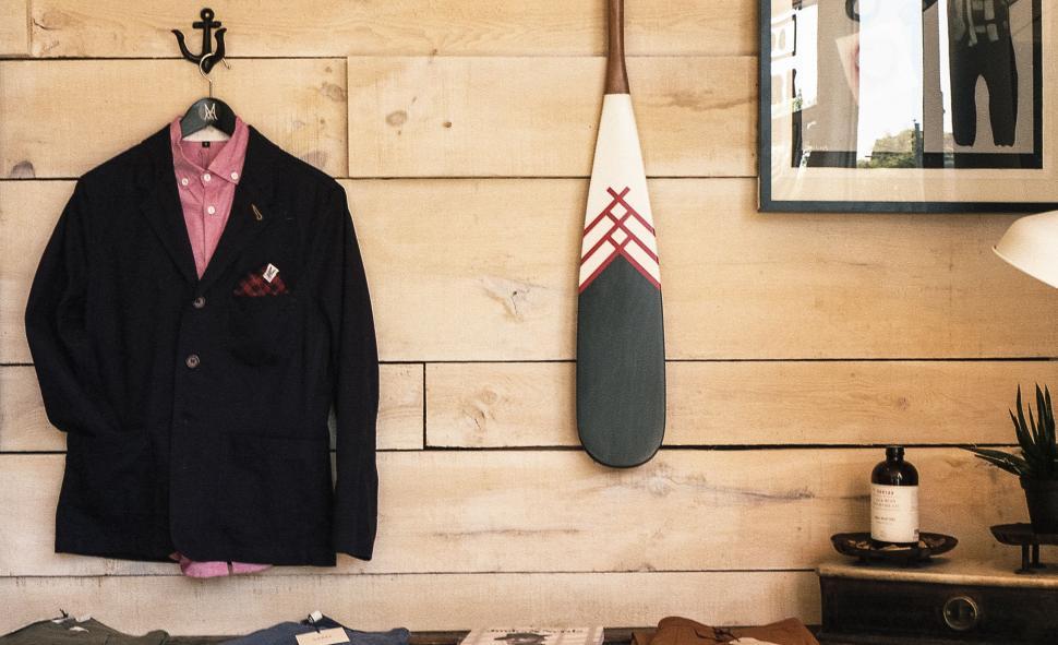Free Image of Suit and Tie Hanging Next to Surfboard 