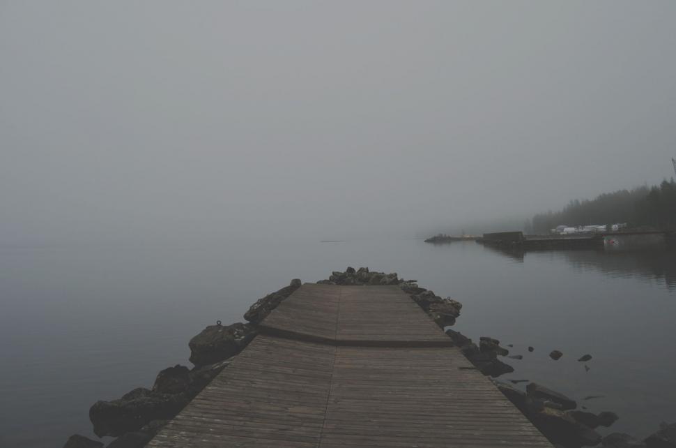 Free Image of Dock in the Middle of a Lake on a Foggy Day 