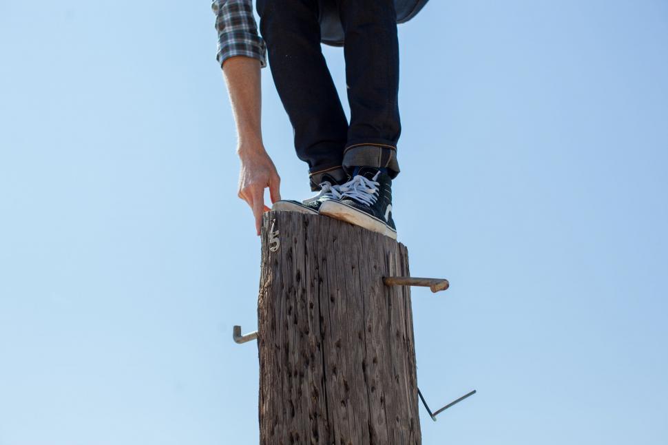 Free Image of Person Skateboarding Jumping Over Wooden Post 