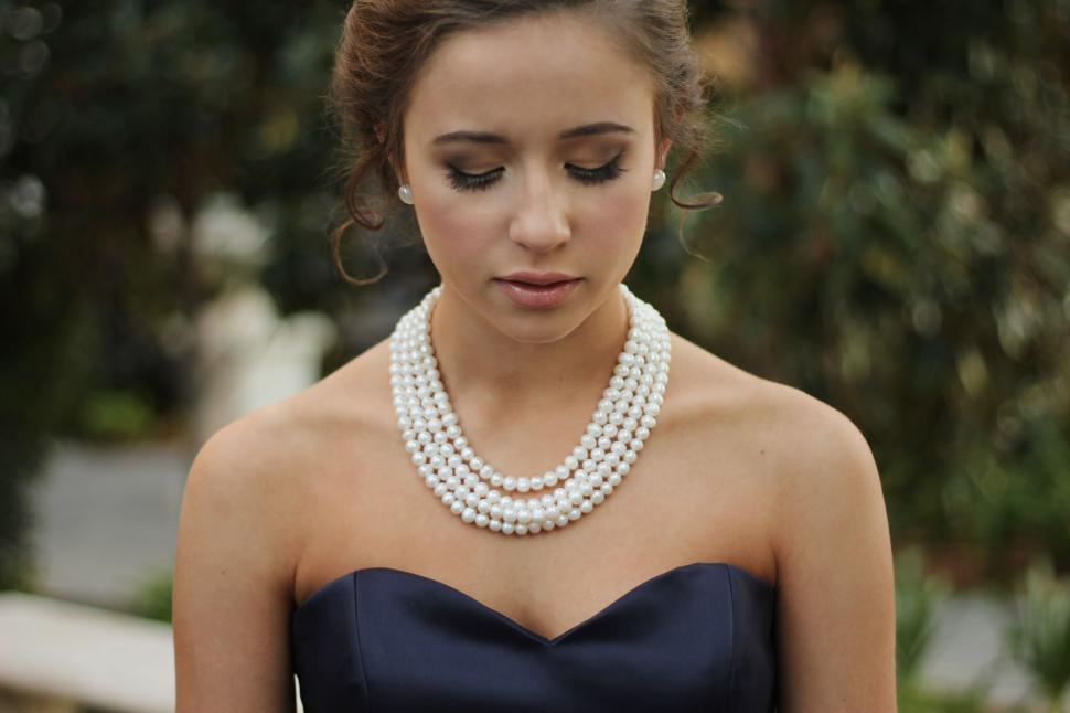 Free Image of Woman in Strapless Dress Wearing Pearl Necklace 