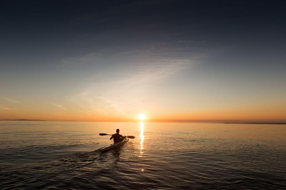 Free Image of Person Riding Surfboard on Body of Water 