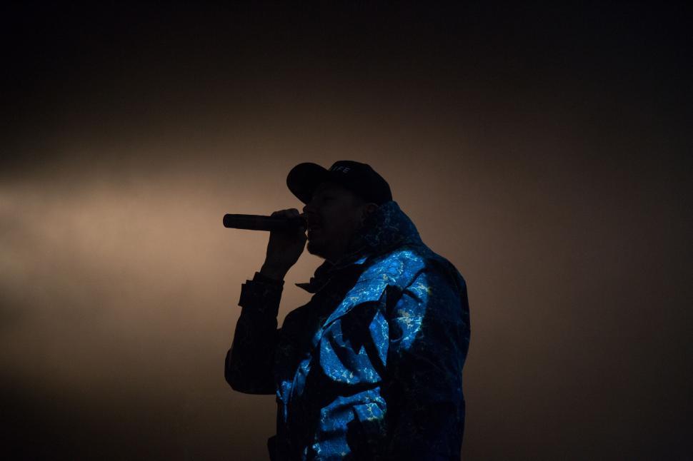 Free Image of Man in Blue Jacket Holding Microphone 