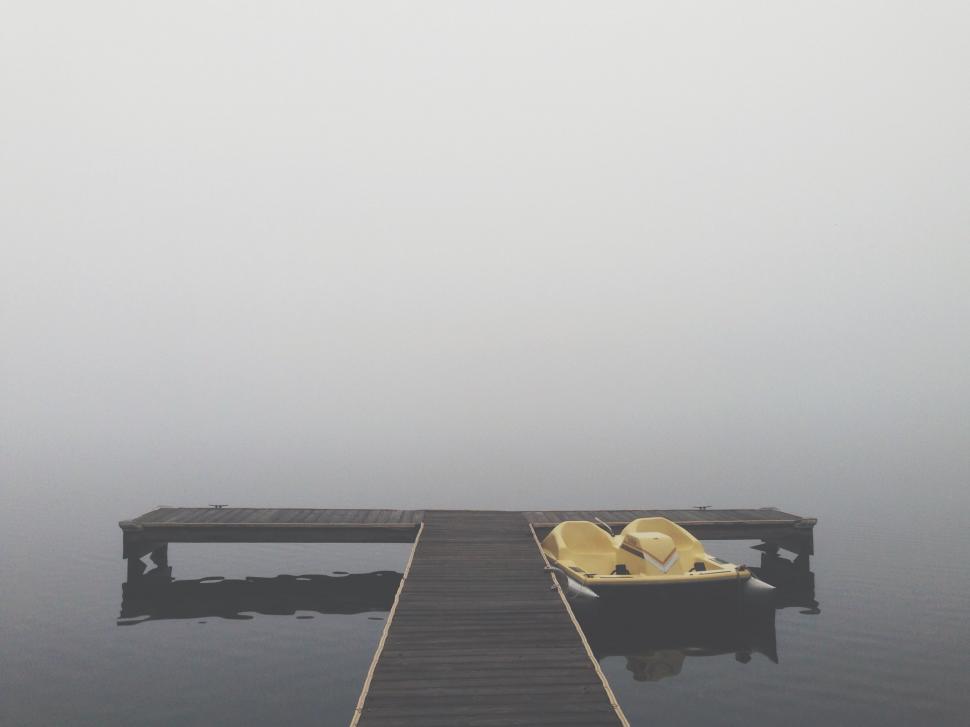 Free Image of Yellow Chair on Dock in Middle of Water 