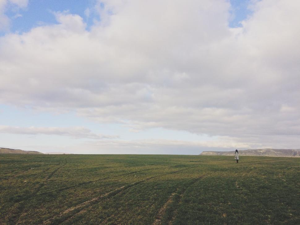 Free Image of Person Standing in Field Flying Kite 