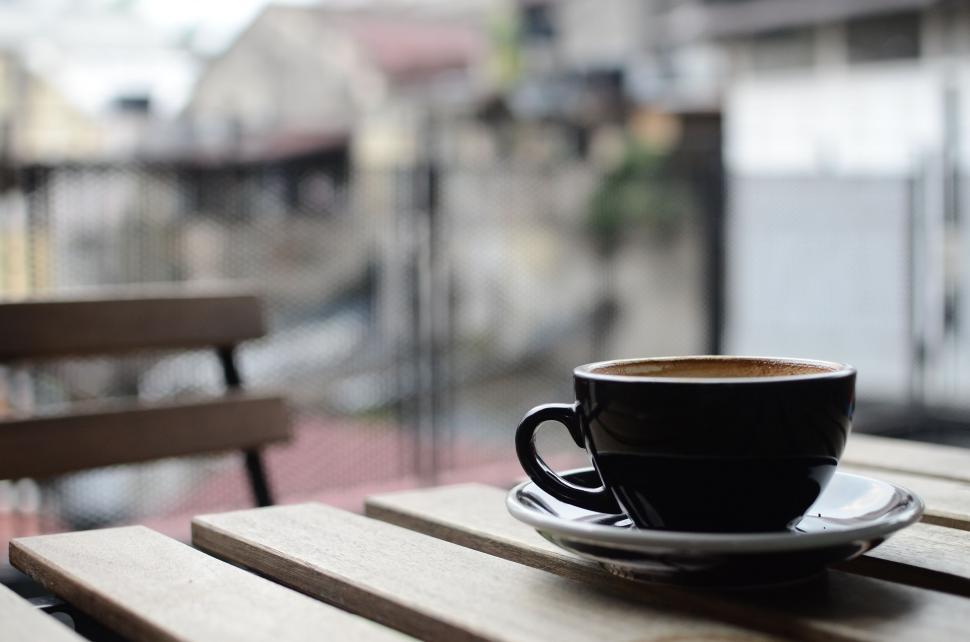 Free Image of A Cup of Coffee on Wooden Table 