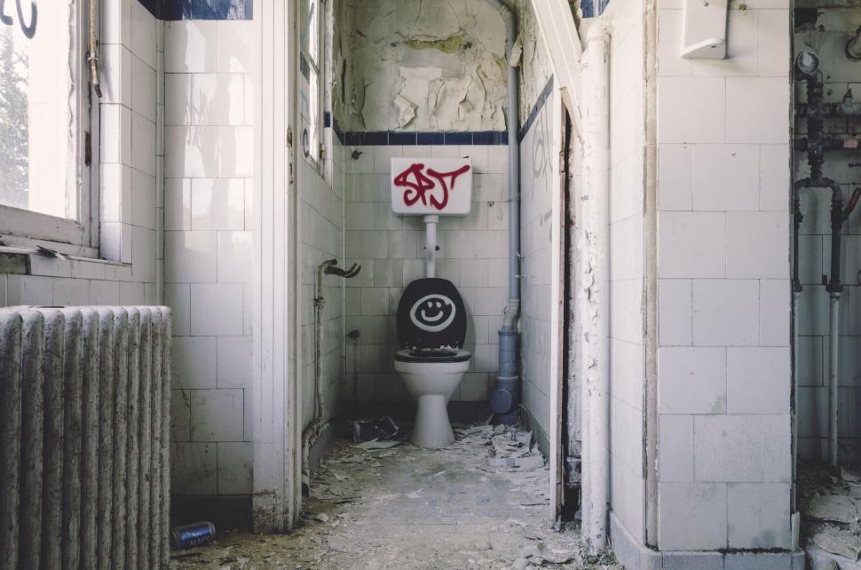 Free Image of Run Down Bathroom With Graffiti-Covered Toilet 