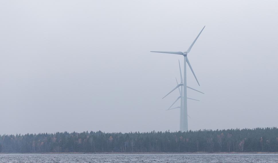 Free Image of Wind Turbine on a Foggy Day Over Body of Water 