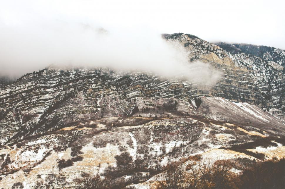 Free Image of Snow-Covered Mountain With Low Clouds 