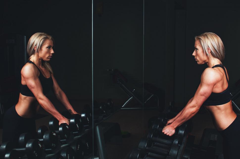 Free Image of Woman in Black Top Exercising on Machine 