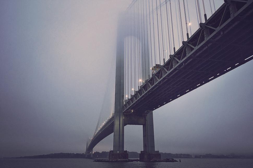 Free Image of Towering Bridge Piercing Through Thick Fog 