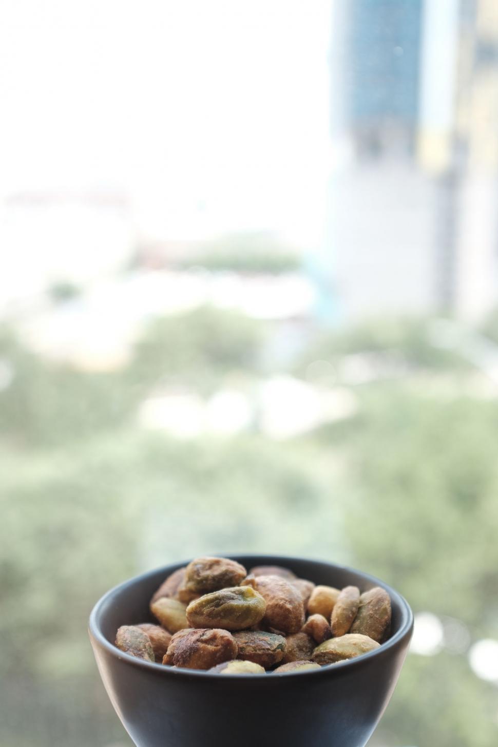 Free Image of Black Bowl Filled With Nuts on Table 