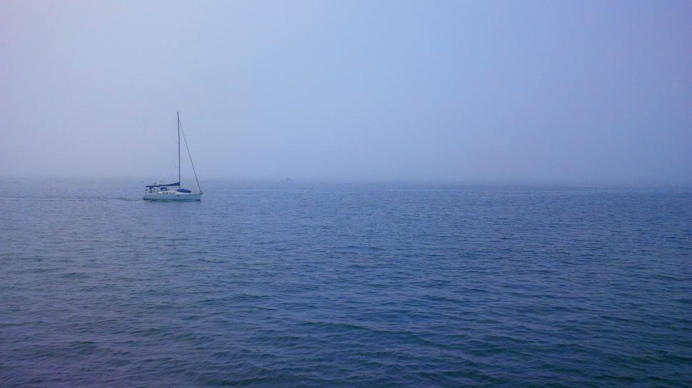 Free Image of Sailboat Sailing in the Ocean on a Foggy Day 