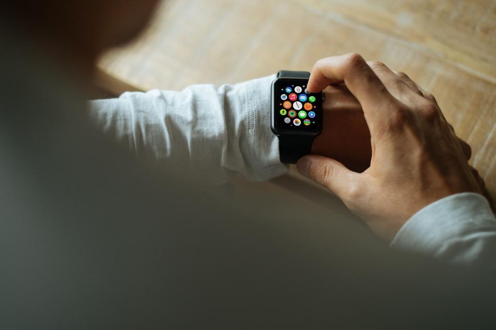 Free Image of Person Holding Smart Watch on Wrist 