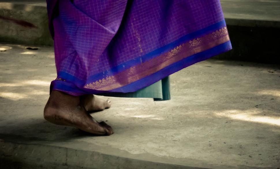Free Image of Close Up of Persons Feet Wearing Purple Sari 